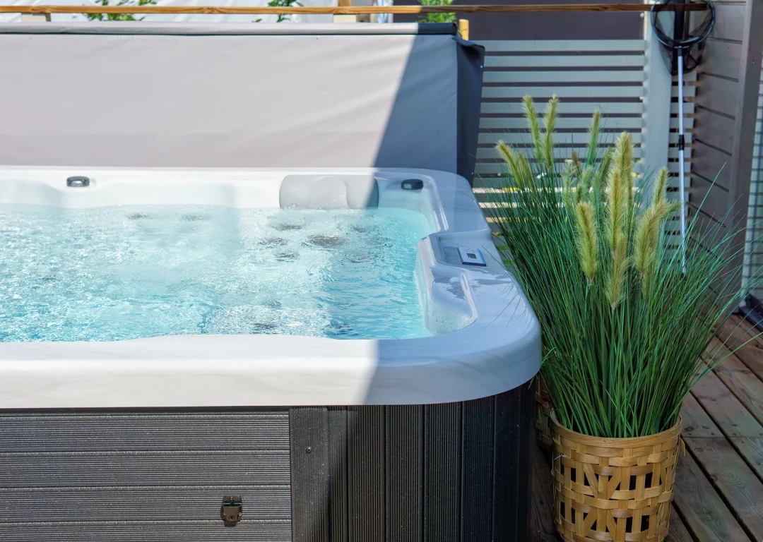 A full outdoor hot tub in garden space.