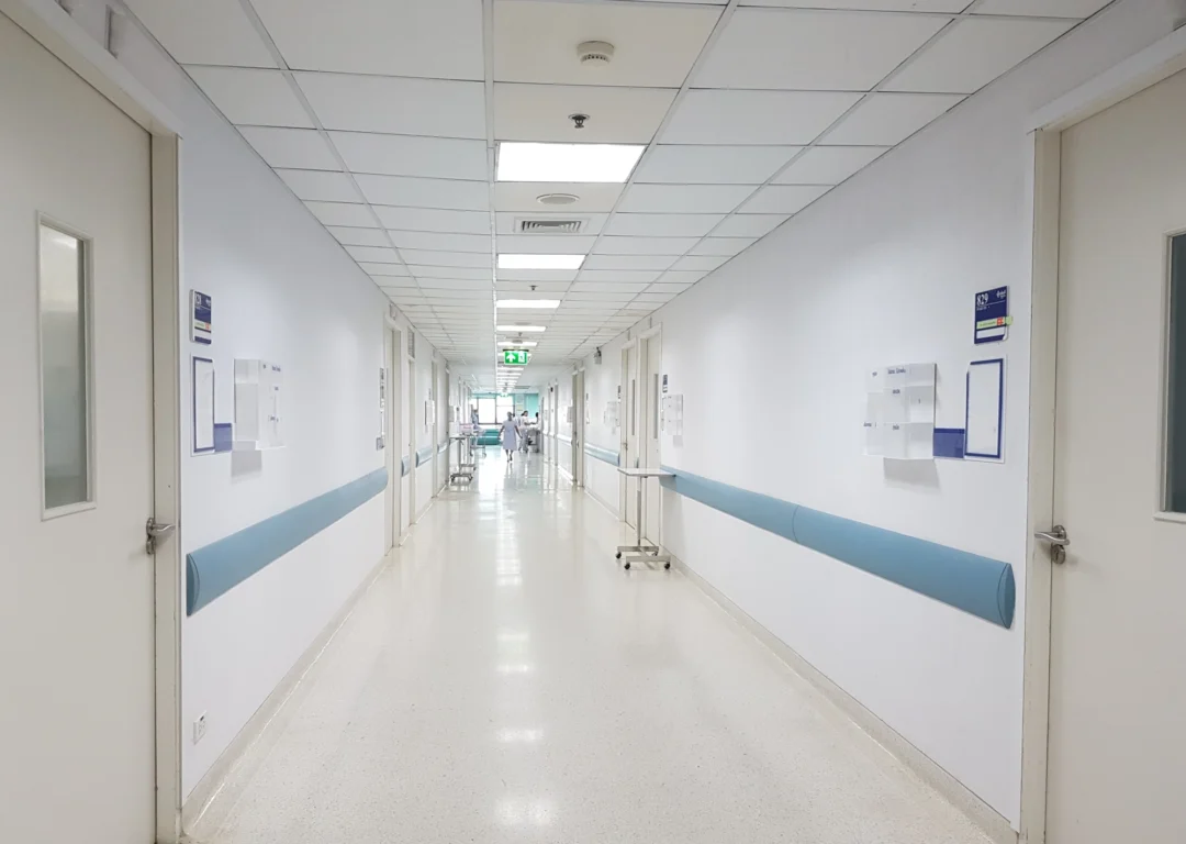 Empty white hospital corridor.